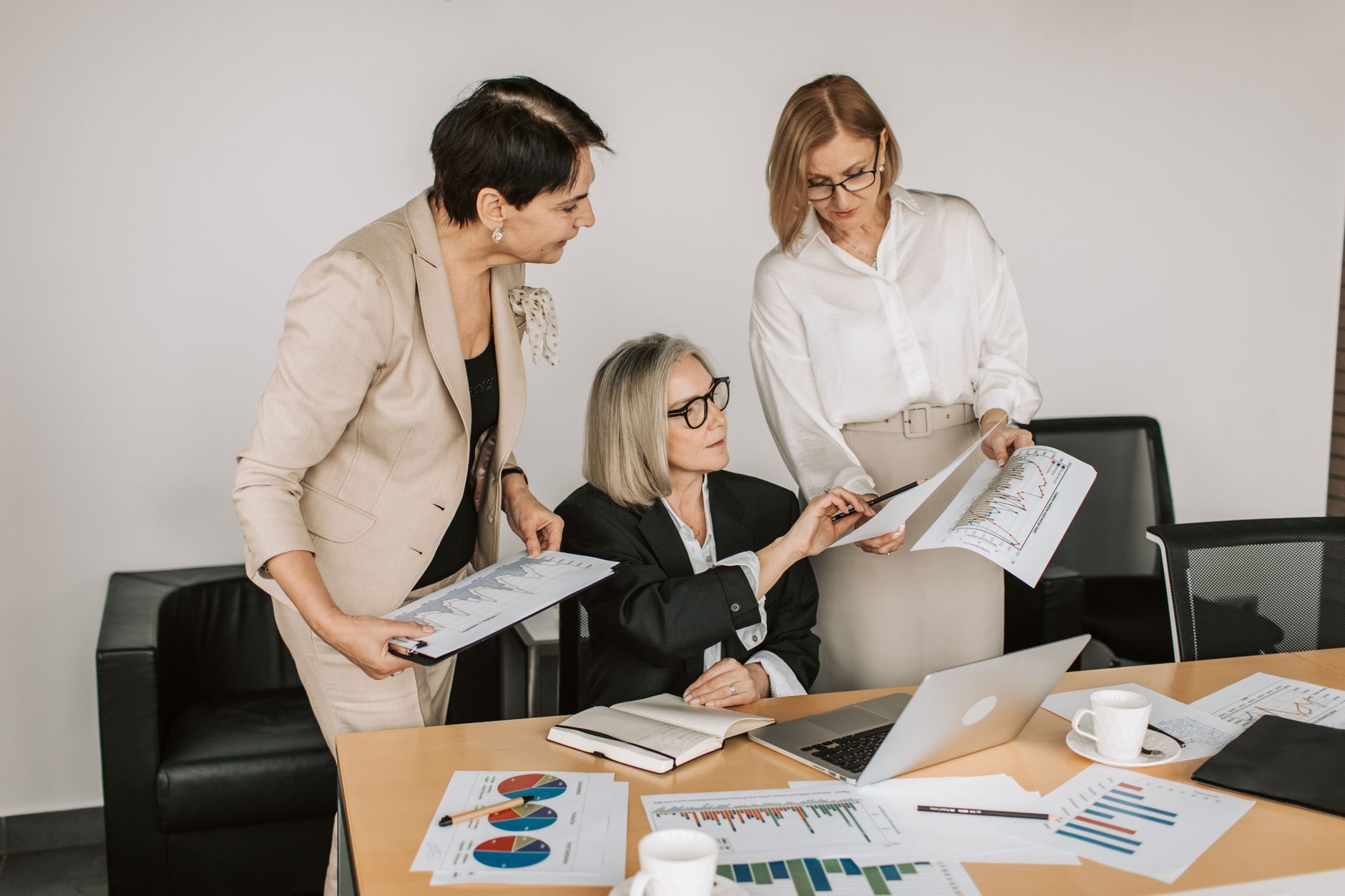 Group of senior businesswomen discussing financial charts during a formal meeting — illustrating: Cloud Backup vs On-Premise Backup: What Actually Makes Sense for Your SMB in Central Florida in 2026